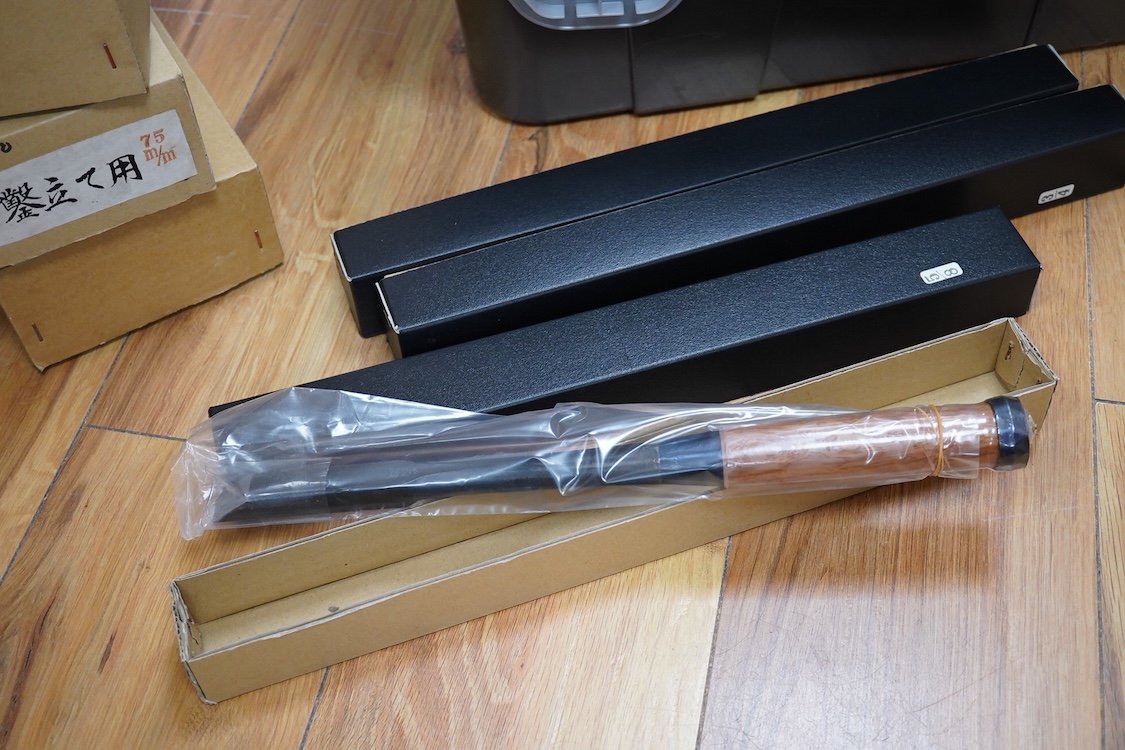 A collection of Japanese woodworking chisels and hammers, including; three boxed large mortise chisels, three boxed timber framing chisels (largest 90mm), and five heavy duty hammers/mallets (11)